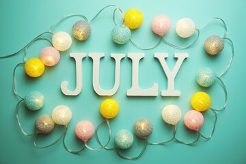 July alphabet letter with cotton ball LED decoration on blue background
