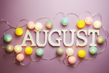 August alphabet letter with cotton ball LED decoration on purple background