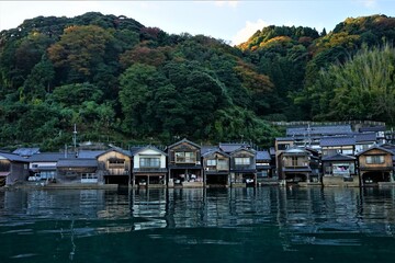 Fototapeta na wymiar View of Funaya, boat houses, at Ine bay in Autumn , Ine city, Kyoto, Japan - 京都 伊根の舟屋 秋の景色