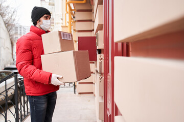 Man holding parcel box while standing near the door entrance