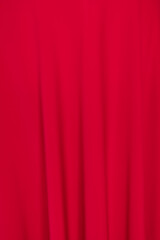 Closeup to red silk fabric background with folds, amazing soft and silky canvas.