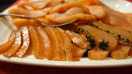 Seasoned and smoked salmon fillet sliced and served
