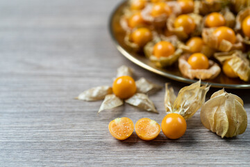 Fototapeta na wymiar Top view pile of cape gooseberry fruit in the gold plate.