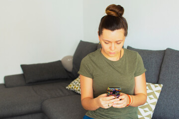 Girl sitting on the couch and writing a message on the phone