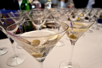 Martini cocktails served on a bar table during fancy evening event party.