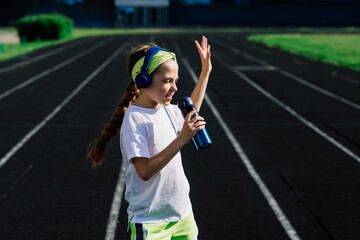 Fototapeta na wymiar Girl jogging on sunny evening, laying on treadmill, stadium, physical training, back to school.