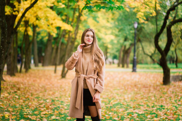 Beautiful woman spending time in park during autumn season