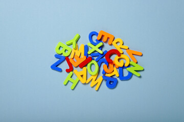 plastic colorful letters of the latin alphabet on a blue background