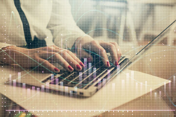 Multi exposure of woman hands typing on computer and financial graph hologram drawing. Stock market analysis concept.