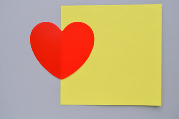 Valentine's day greeting card with red heart on yellow and gray background