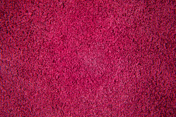 Close up of red suede leather texture. Colored chamois fabric background.