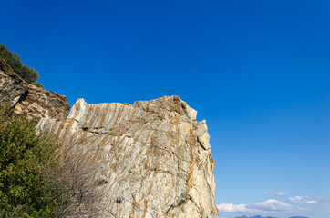 Rocks near the coast of the Mediterranean sea on a background of mountains in Turkey