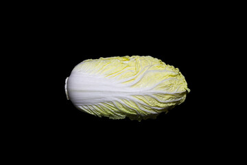 Single Chinese cabbage isolated on black background.