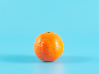 Orange tangerine on blue background