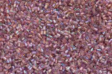 Background texture of pink beads closeup. Seamless beads texture. Hobbies, handmade jewelry, craft. Abstract background