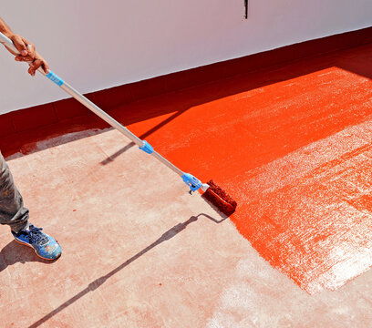 Waterproofing the house terrace with red rubber waterproof coating paint. 
