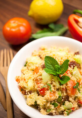 fresh tabbouleh salad on a wooden background