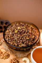 Kutia is a wheat Christmas porridge.  Traditional Christmas dish of the Slavs. Kutia with raisins, nuts, poppy and honey on dark background. Top view. Christmas atmosphere. 