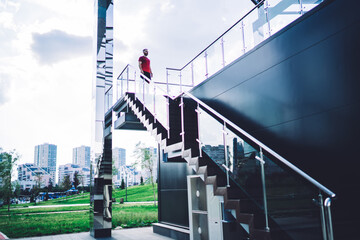 Man standing on spiral staircase on stairway