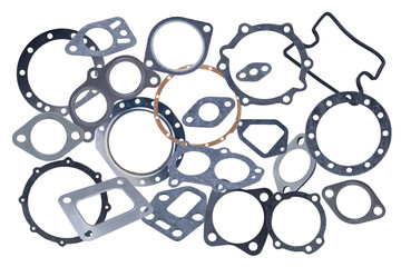 Set of several different metal and paronite engine gaskets, isolated on a white background