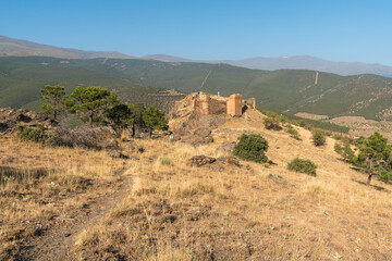 Fototapeta premium Ruins of an old castle on top of a mountain