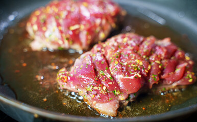 Duck fillet is cooked in a skillet.