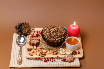 Kutia is a sweet wheat porridge of the Slavs. Traditional Christmas dish of the orthodox christians. Christmas kutia with honey, nuts, poppy, raisins and spices. Christmas eve food. Top view.