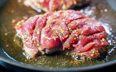 Duck fillet is cooked in a skillet.