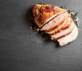 Sliced duck fillet on granite plate.