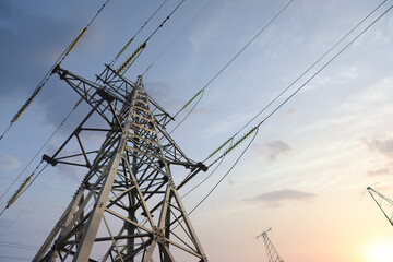 High voltage tower at sunset, low angle view