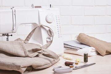 the process of sewing eco bags, thread, scissors and a sewing machine