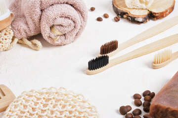 bamboo toothbrushes and bathroom accessories made from natural materials on a beige background