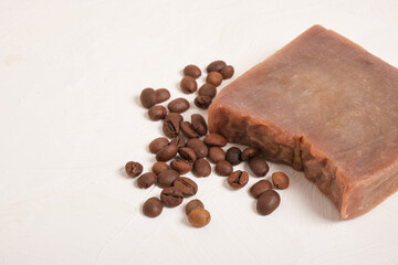 piece of cocoa homemade soap and coffee beans, beige background