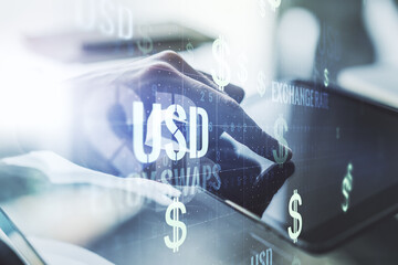 Double exposure of creative USD symbols hologram and finger clicks on a digital tablet on background. Banking and investing concept