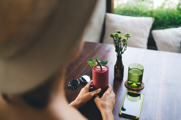 Crop woman with fresh beverage