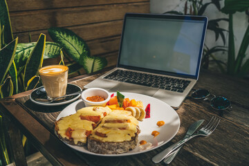 Laptop and coffee in cozy cafe