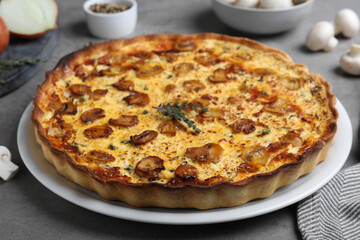 Delicious homemade mushroom pie on grey table, closeup