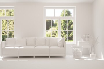 Fototapeta premium White living room with sofa and summer landscape in window. Scandinavian interior design. 3D illustration
