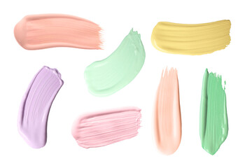 Set with strokes of color correcting concealers on white background, top view