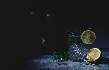 a splashing ice cube into a Gin Tonic - obrazy, fototapety, plakaty