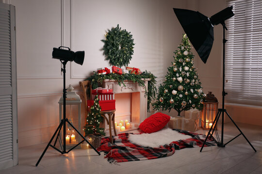 Beautiful Christmas themed photo zone with professional equipment and fireplace