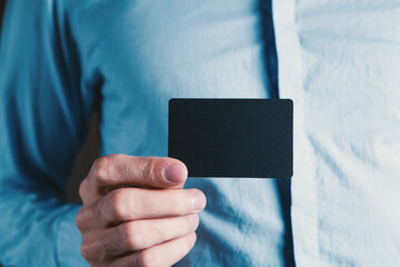man holding a small paper in his hand