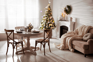 Festive table setting and beautiful Christmas decor in living room. Interior design