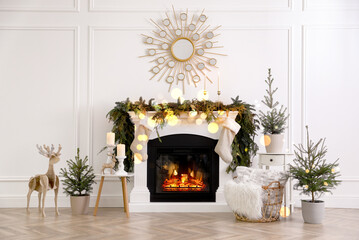 Stylish room interior with fireplace and beautiful Christmas decor