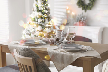 Festive table setting and beautiful Christmas decor in living room. Interior design