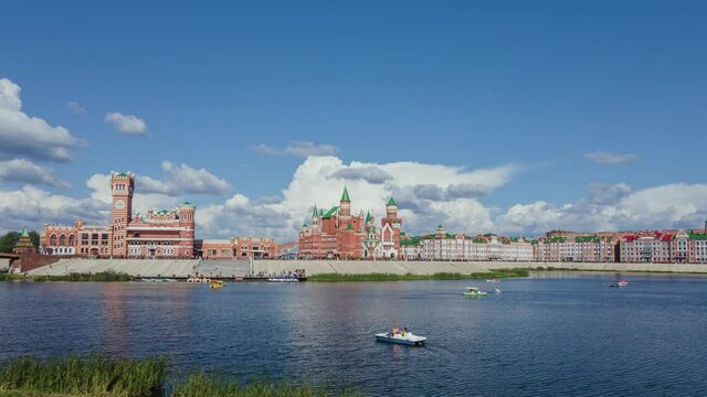 Embankment Kokshaga river. Russia. Movement of catamarans and boats on the river. Beautiful blue sky with clouds. Summer time. Hyperlapse. Drone footage