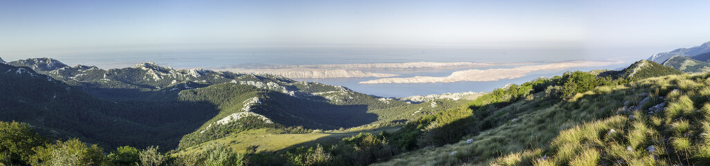 Fototapeta na wymiar Panoramatic view on mountains after sunrise in croatian national park Velebit.