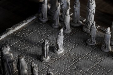 A black and white portrait of the beginning of a strategic game of chess with two pawns facing...
