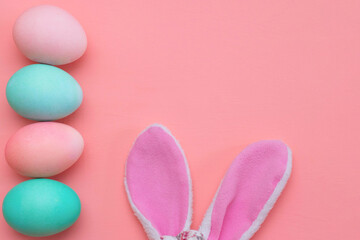 Obraz na płótnie Canvas Easter decor: pastel eggs and bunny ears. Preparing for Easter. The photo