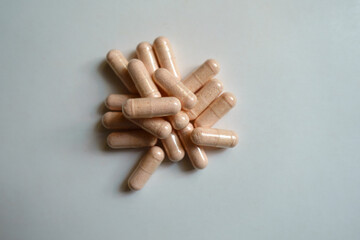 Top view of heap of pink capsules of probiotic dietary supplements